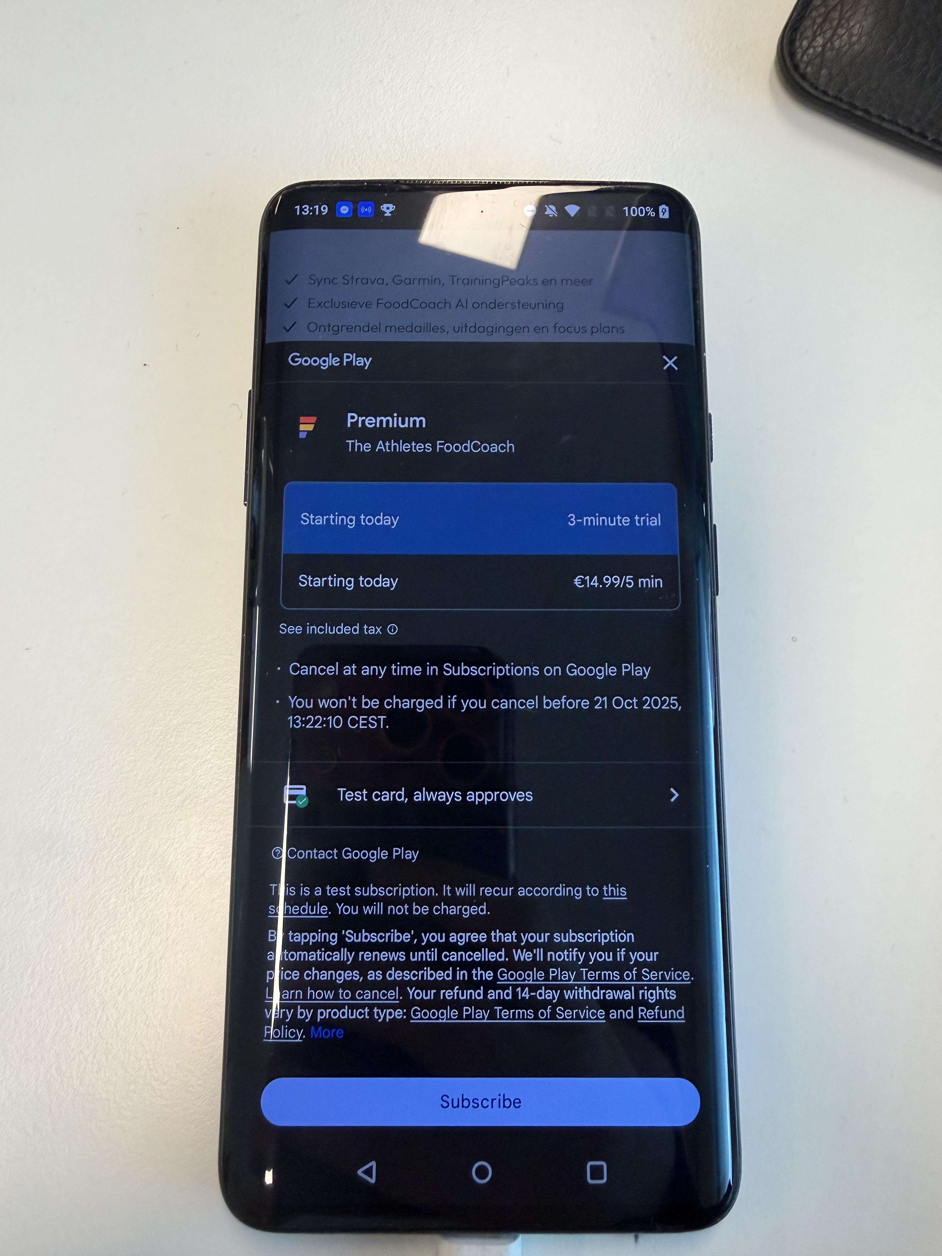 Android phone showing a subscription popover with the payment method "Test card, always approves"